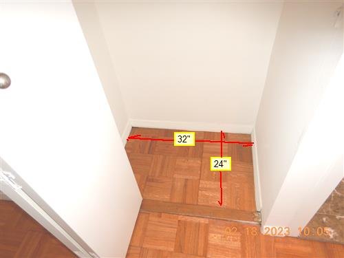 Empty closet alcove with parquet floor, red dimension lines marked 32 inches by 24 inches