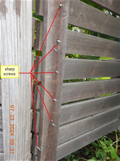 Weathered wood gate with red lines pointing to a column of protruding screw tips, labelled sharp screws
