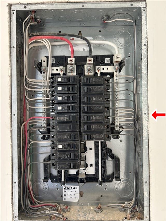 A residential electrical panel photographed with the dead front cover removed, showing breakers, neutral bars and branch circuit conductors.