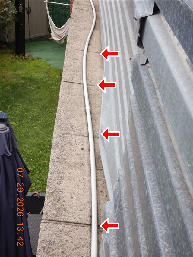 A blocked gutter full of debris, photographed during an inspection.