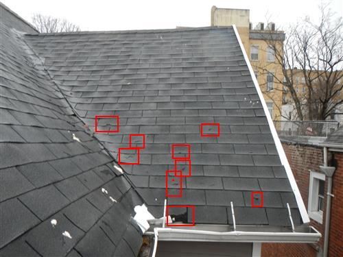 A roof photograph with the defects marked directly on the image in the report.