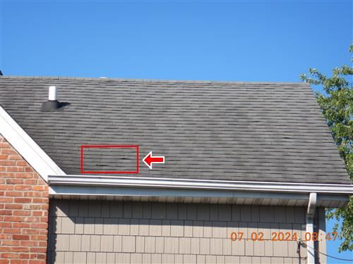A roof area marked up in an inspection report photograph.