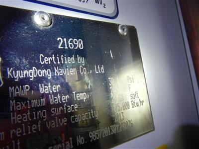 The manufacturer's certification plate on a gas boiler listing ratings, capacity, and year
