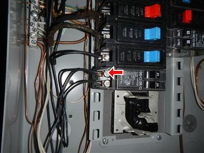 Inside of an electrical panel, red arrow at a breaker terminal with two wires under one lug